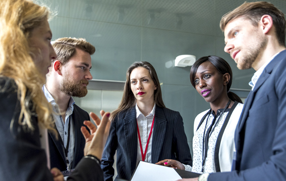 A group of automation and robotics professionals network and swap ideas at the conference and expo.